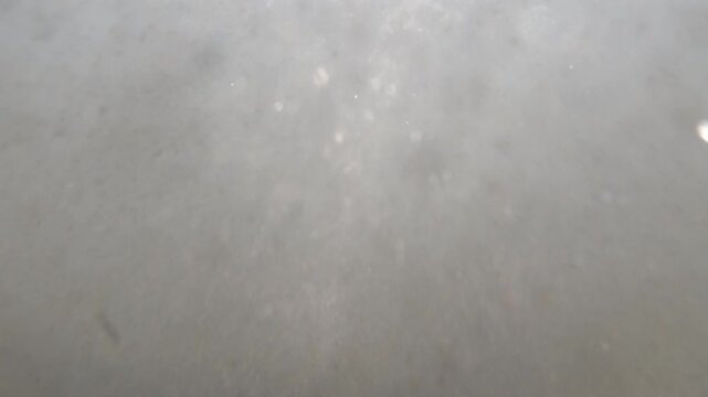 Dark gray surface showing an abstract textured background. Tiny imperfections and a subtle gradient create visual depth