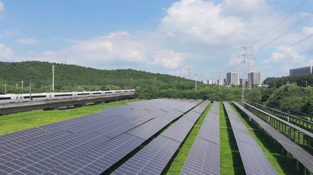 Drone gliding forward above solar panels and green hills