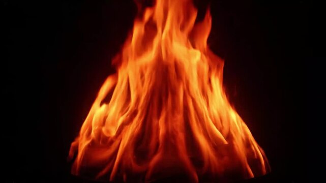 Bright Orange Fire Flames Rising Upward Against Black Background Close-Up