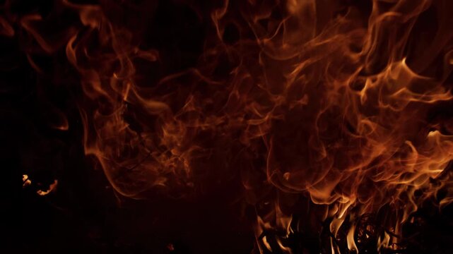 Fire flames filling darkness. Fire burning dynamic movement. Fire blazing hot energy. Fire abstract background texture.
