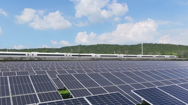 High speed train passing solar panels in a green landscape