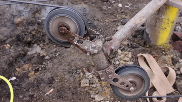Watch a machine part move during a construction project in a work area on a bright sunny day