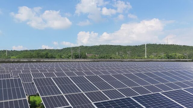 Aerial view gliding across long rows of solar panels