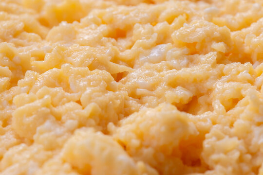 Organic scrambled egg, made with chicken eggs, butter and milk, background backdrop. Healthy breakfast food concept.