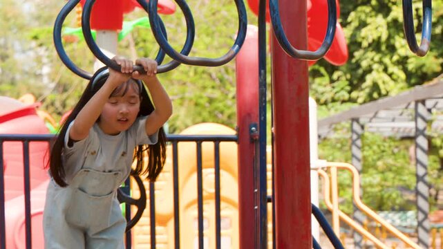 Young Thai Girl Playing on Monkey Bars at Lumpini Park