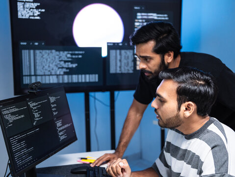 Team engineers software development are brainstorming using computer writing code. Programmer teamwork meetings using technology artificial intelligence work system about cyber security and coding 