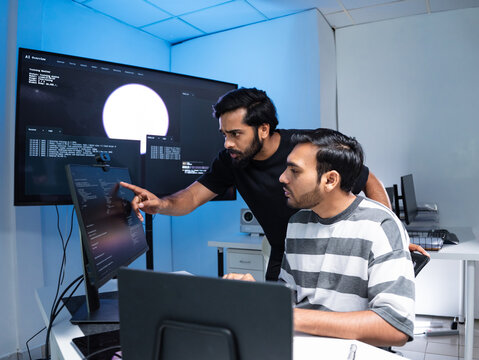 Team engineers software development are brainstorming using computer writing code. Programmer teamwork meetings using technology artificial intelligence work system about cyber security and coding 