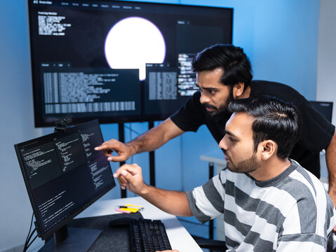 Team engineers software development are brainstorming using computer writing code. Programmer teamwork meetings using technology artificial intelligence work system about cyber security and coding 