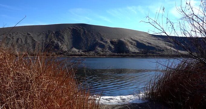 Scenic lake in front of sand dune in Bruneau Dunes State Park, Idaho