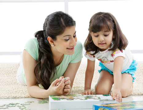 Mother and daughter solving a puzzle 