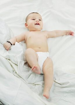 A baby lying in bed 