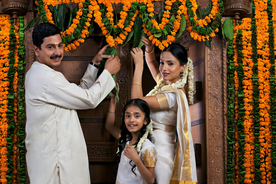South Indian family decorating during Onam festival 