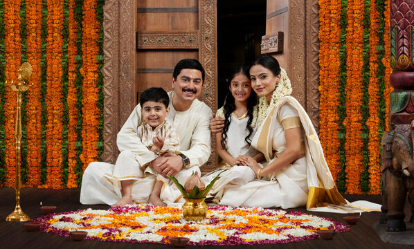 South Indian family with flower rangoli 