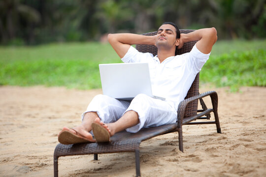 Man taking a nap at a beach 