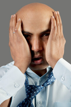 Bald man getting frustrated 
