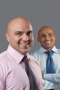Portrait of two bald executives 
