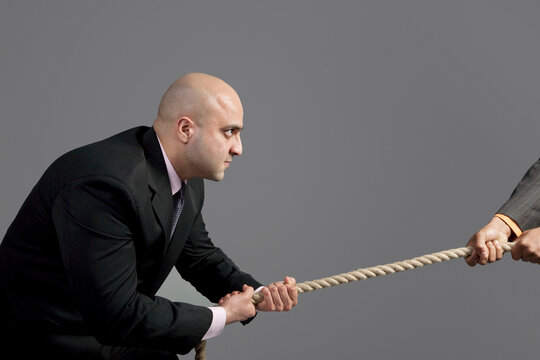 Businessman pulling on a rope 