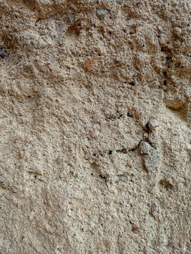 Macro shot of rough dry brown earth surface texture as background.