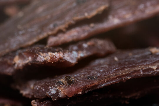 Close-up view of delicious cured beef jerky slices stacked together as a tasty snack