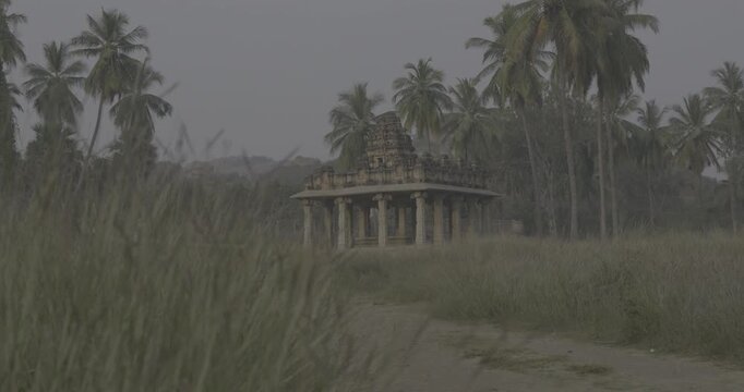 Silhouette of ancient temple Gopuram entrance tower at dusk in Hampi