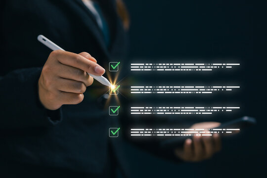 Business professional using a digital checklist interface with green check marks, representing task completion, quality control, workflow management, compliance, and online approval.
