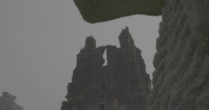 Silhouette of ancient temple Gopuram entrance tower at dusk in Hampi