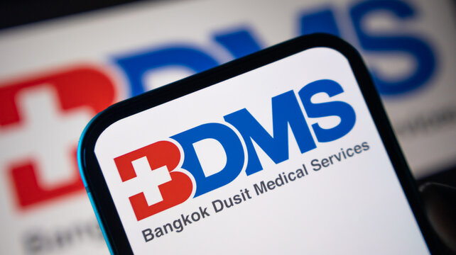 Bangkok dusit medical services logo displayed on smartphone screen with healthcare branding aesthetic.