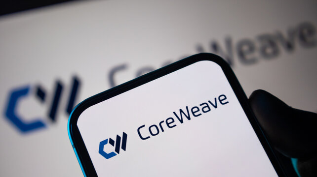 Coreweave logo displayed on smartphone screen with professional blue branding for technology and cloud computing news articles.
