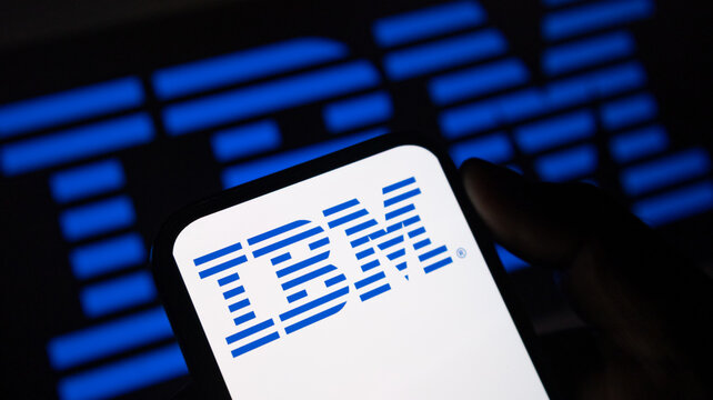 IBM brand logo on mobile device screen with dark blue ambient light for cybersecurity and data server concepts.