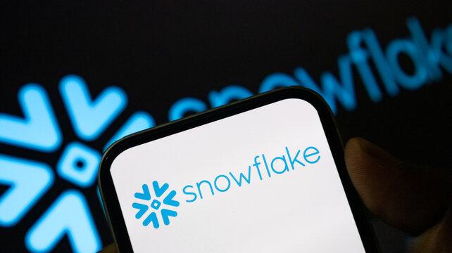 Snowflake software logo on mobile phone screen for cloud data management visualization.