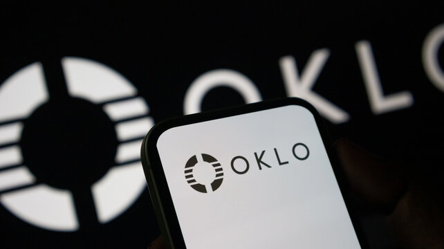 Oklo inc logo glowing on smartphone screen against black corporate background.