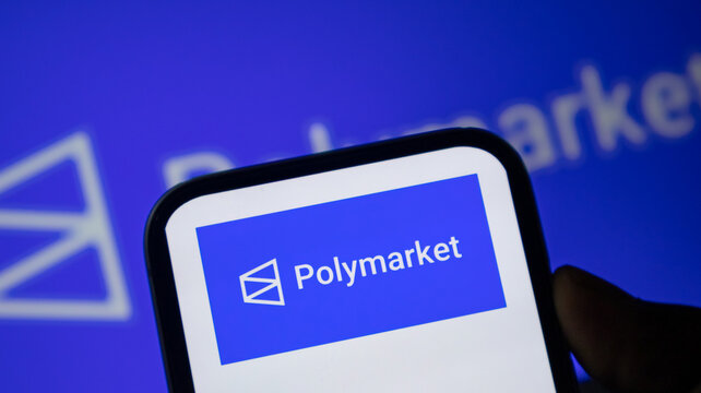 Polymarket logo on mobile phone screen representing decentralized prediction market technology.