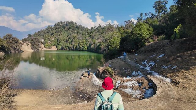 Hiker at Deoria Tal lake near Chopta Uttarakhand with Tungnath temple region mountain views