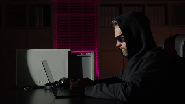 Cybercrime hackers and digital information. Hacker typing malware code. Wanted Hacker. Hacker hack private information. Night hacker working on laptop.