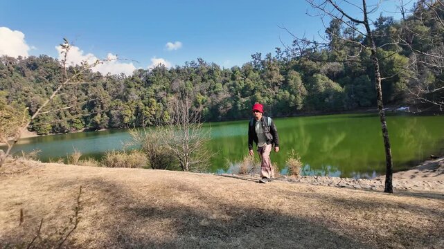Hiker walking near Deoria Tal lake in Chopta Uttarakhand near Tungnath temple region