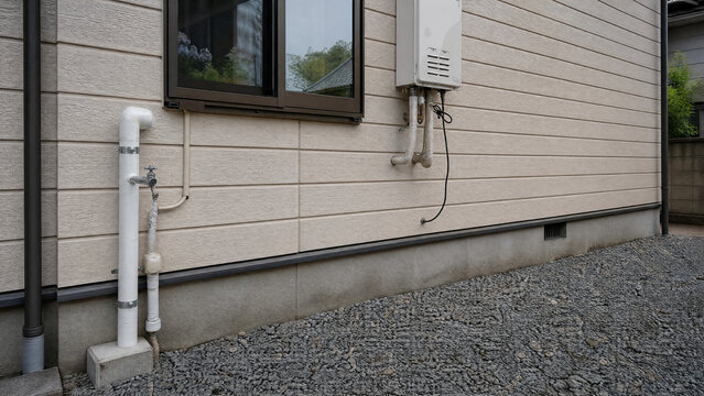 Replaced and lagged water pipe on a Japanese house wall - insurance claim - copy space