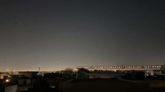 Orange Line Metro train moving at night in Lahore Pakistan during Basant.