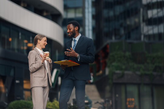 Business colleagues collaborating and discussing in urban setting