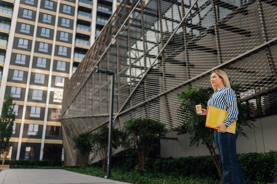 Successful businesswoman looking ahead in urban environment