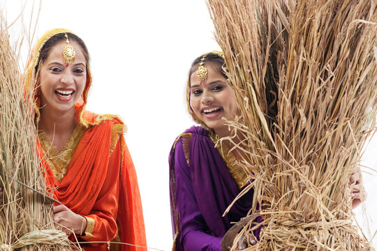 Sikh women with sickles and hay bales 