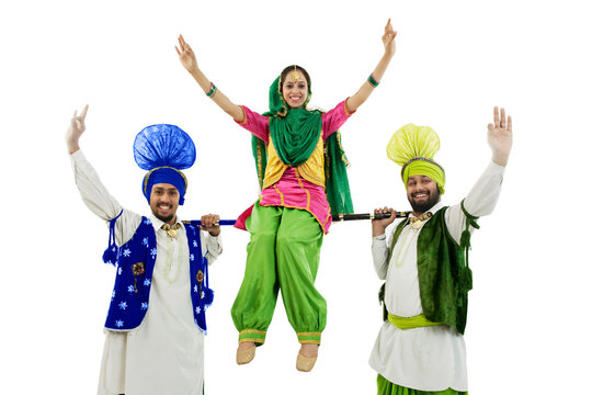 Woman sitting on a Khundi resting on two mens shoulders 