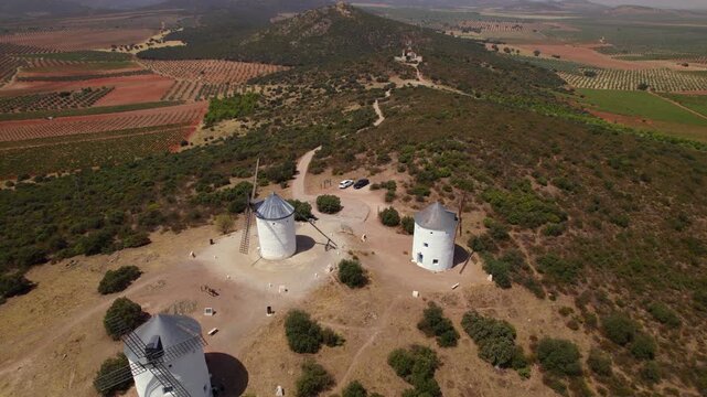 Aerial view of historic white windmills of Don Quixote in Puerto Lapice, Spain, on a sunny day