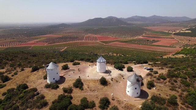 Puerto Lapice historic windmills from aerial drone view over La Mancha landscape in Spain with sunny weather
