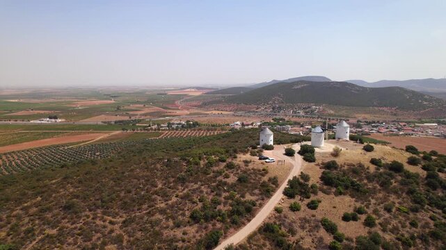 Traditional windmills of Don Quixote in Puerto Lapice on a sunny day in La Mancha, Spain, famous for its cultural heritage