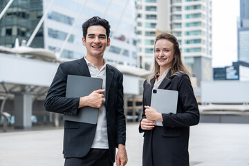 Fototapeta premium portrait young caucasian business people conducting outdoor real estate and property project inspection at financial district