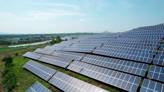 A large-scale solar photovoltaic power farm installed on hilly open land, generating clean renewable energy.