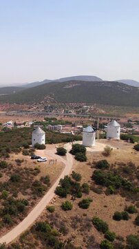 Traditional spanish windmills on a hill overlooking Puerto Lapice village in La Mancha, Spain, an historic landmark