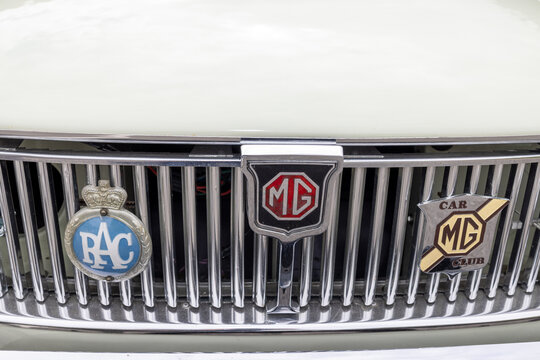 Harrogate, Yorkshire UK 17th August 2026: Close up front view of a classic MG car featuring a chrome vertical grille with MG badge RAC emblem and MG Car Club badge mounted prominently across the front
