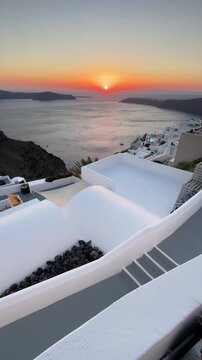 Beautiful sunset in Santorini island, Greece. White architecture with sea view. Blue sea and the blue sky at sunset. Summer travel and vacation. Vertical video
