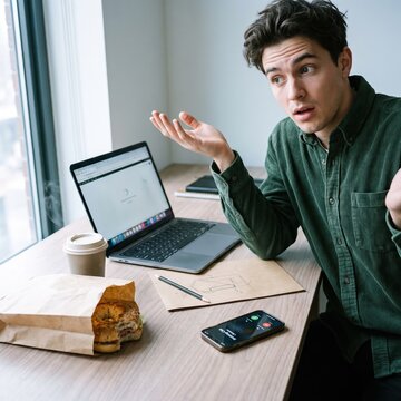Generative AI, Confused young man reacting to a problem during a work lunch break